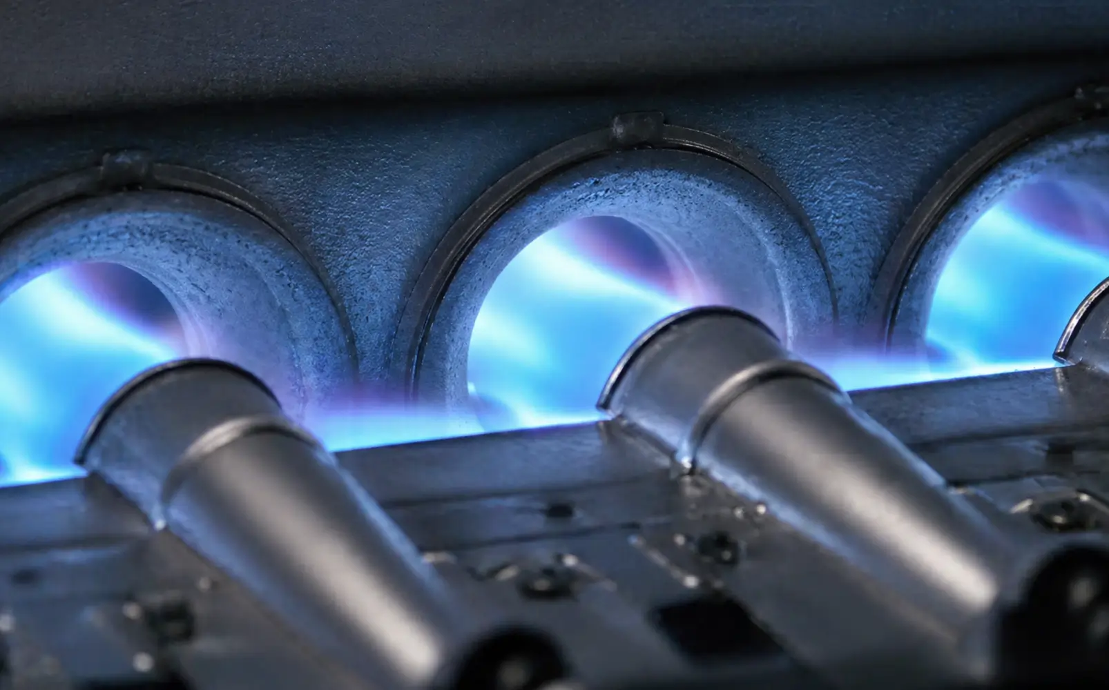 Emergency Furnace Burner & Heating Repair Blue flames burning steadily inside a residential gas furnace burner assembly during a heating repair diagnostic by K Komfort.