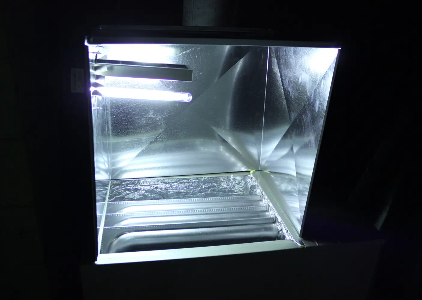 HVAC UV Germicidal Light Installation An active HVAC UV light system illuminating the interior metal ductwork and evaporator coil to kill airborne bacteria and mold inside a residential heating and cooling system installed by K Komfort in Milwaukee, Wisconsin.