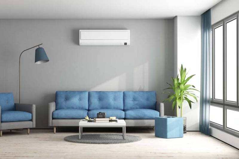 Ductless Mini Splits for Comfortable and Healthy Living. Blue and gray modern living room with sofa, armchair, and air conditioner.
