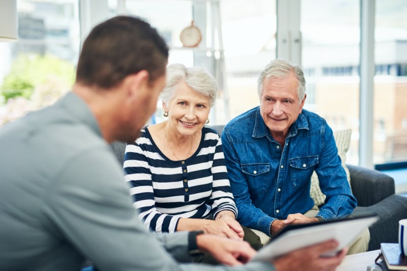 Should I Get an 80 or 95 Percent Furnace? Shot of senior couple having a consultation with a financial advisor at home.