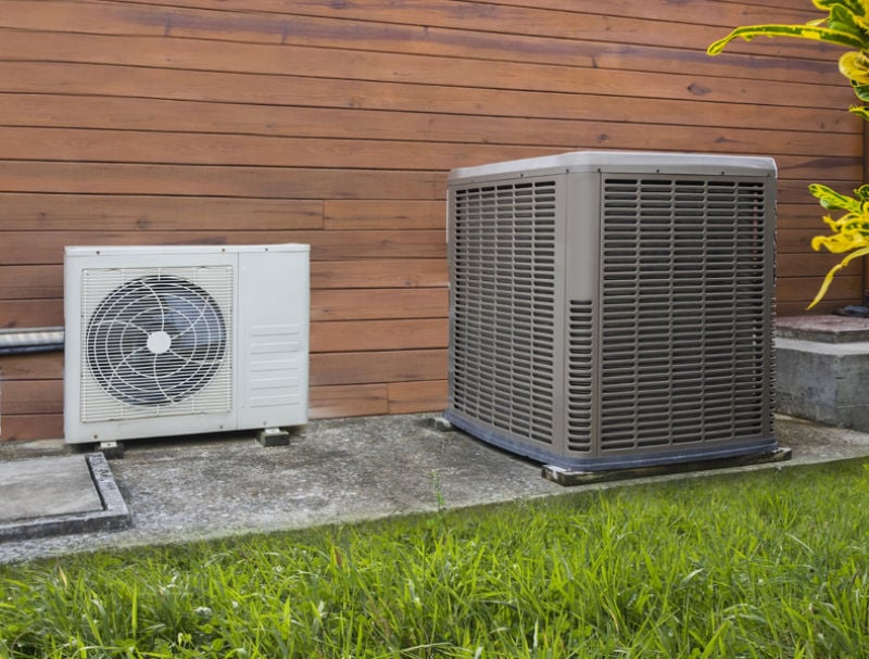 Air conditioning heat pumps on the side of a house