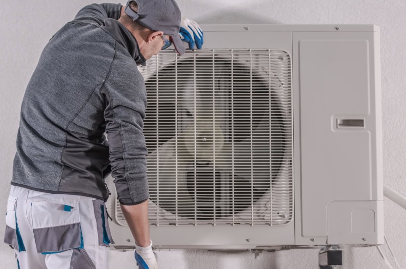 Modern Heat Pump Repair by Caucasian Technician in His 30s.