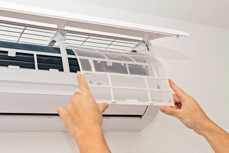 Image of someone changing filter in ductless system. What Maintenance Is Needed for a Ductless System?